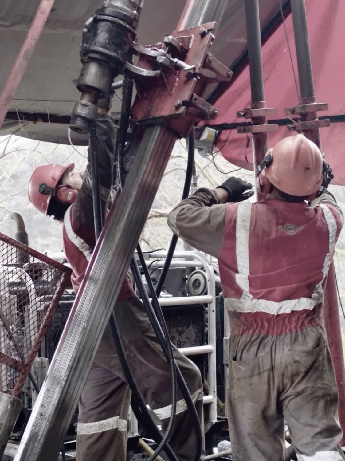 Drillers in full PPE at a Copalquin man-portable rig